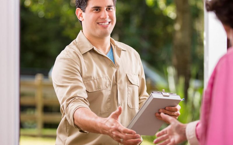 Technician reviewing HVAC checklist with homeowner